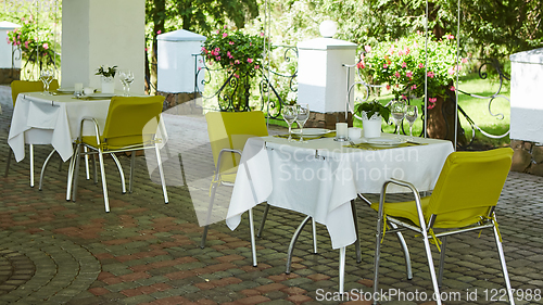 Image of terrace summer cafe with tables and chairs for people, an empty institution for recreation, nobody