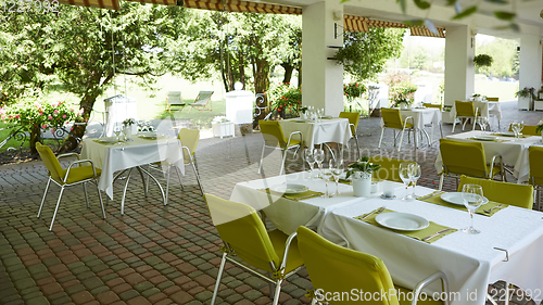 Image of terrace summer cafe with tables and chairs for people, an empty institution for recreation, nobody