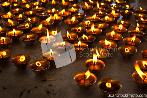 Image of Burning candles in Buddhist temple. McLeod Ganj, Himachal Pradesh