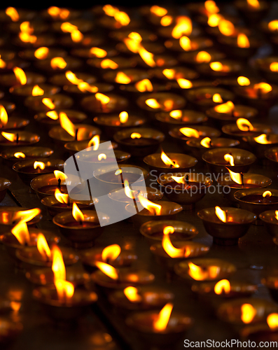 Image of Burning candles in Buddhist temple. McLeod Ganj, Himachal Prades