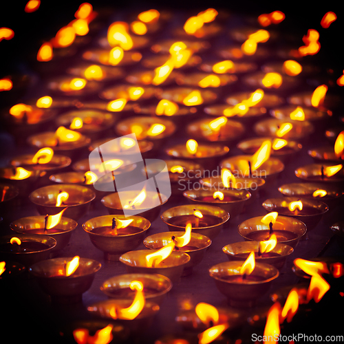 Image of Burning candles in Buddhist temple, McLeod Ganj