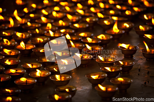 Image of Burning candles in Buddhist temple. McLeod Ganj, Himachal Pradesh