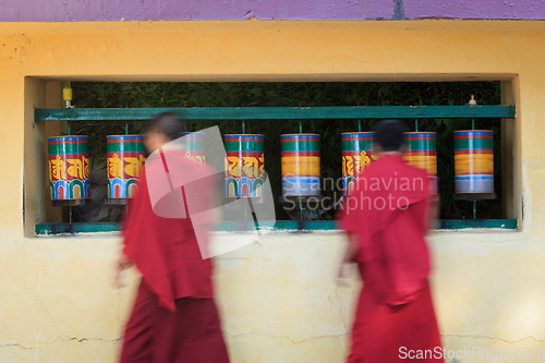 Image of Buddhist monks rotating prayer wheels in McLeod Ganj