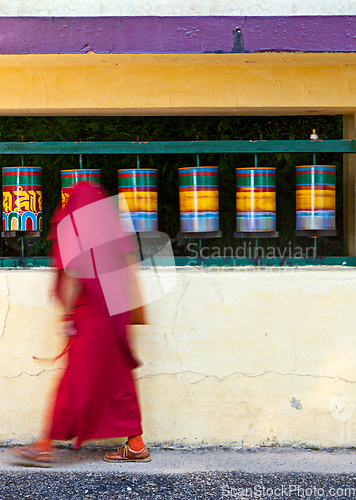 Image of Buddhist monk rotating prayer wheels in McLeod Ganj