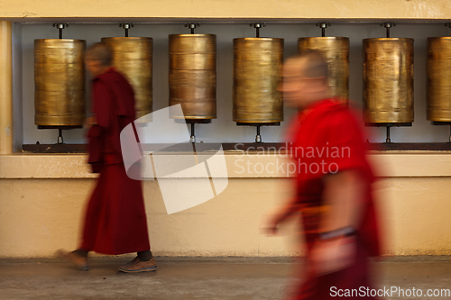 Image of Buddhist monk rotating prayer wheels in McLeod Ganj