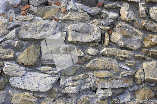 Image of Very old wall from stones of various shapes and red bricks