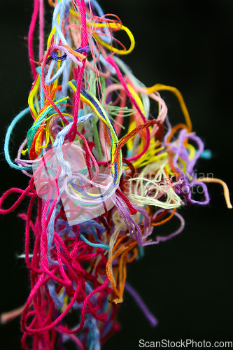 Image of Multicolored tangled threads for needlework on black background