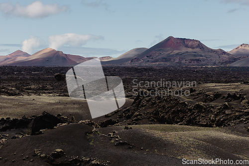 Image of Black volcanic landscape of Timanfaya National Park in Lanzarote. Popular touristic attraction in Lanzarote island, Canary Islands, Spain.