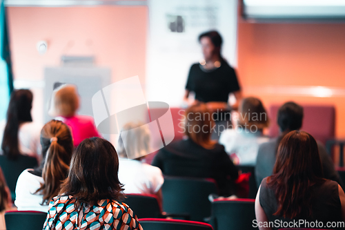 Image of Woman giving presentation on business conference event.