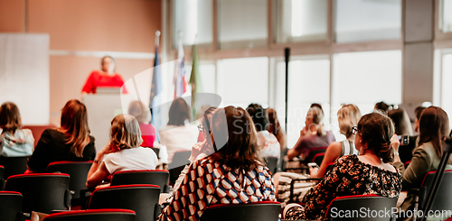 Image of Woman giving presentation on business conference event.