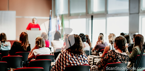 Image of Woman giving presentation on business conference event.