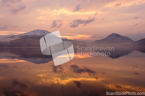 Image of evening atmosphere with clouds reflecting in the sea