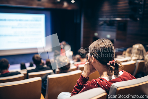 Image of Woman giving presentation on business conference event.