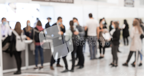 Image of Abstract blured people at exhibition hall of expo event trade show. Business convention show or job fair. Business concept background.