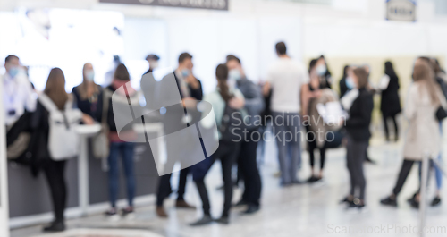 Image of Abstract blured people at exhibition hall of expo event trade show. Business convention show or job fair. Business concept background.