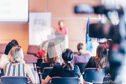 Image of Woman giving presentation on business conference event.