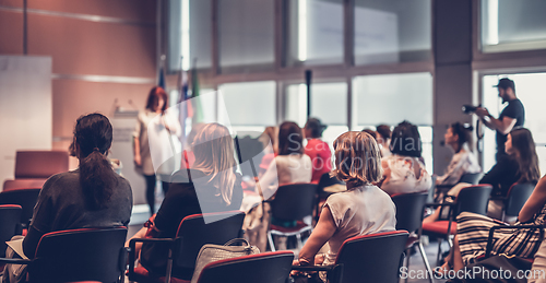 Image of Woman giving presentation on business conference event.