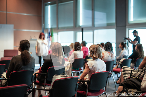 Image of Woman giving presentation on business conference event.