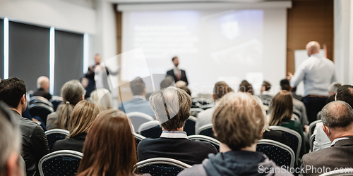 Image of I have a question. Group of business people sitting in conference hall. Businessman raising his arm. Conference and Presentation. Business and Entrepreneurship