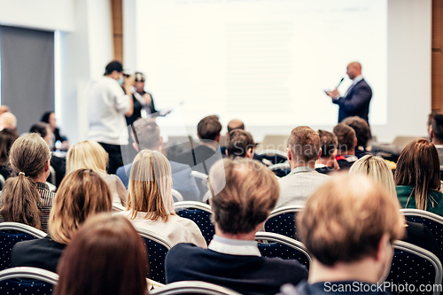 Image of I have a question. Group of business people sitting in conference hall. Businessman raising his arm. Conference and Presentation. Business and Entrepreneurship