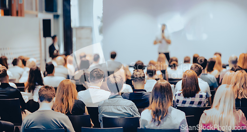 Image of Business speaker giving a talk at business conference event.