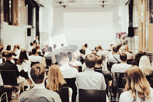 Image of Business speaker giving a talk at business conference event.