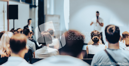 Image of Business speaker giving a talk at business conference event.