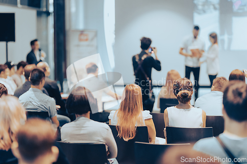 Image of Business speaker giving a talk at business conference event.