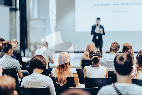 Image of Business speaker giving a talk at business conference event.