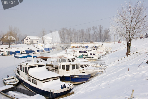 Image of old boats in frozen marina