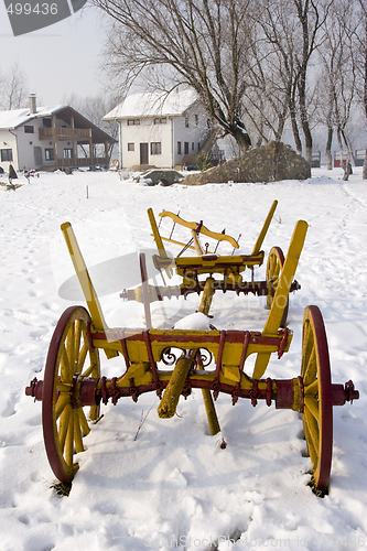 Image of old farm cart in the snow