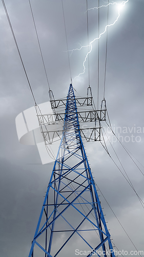 Image of High voltage tower against the cloudy sky with lightning strike