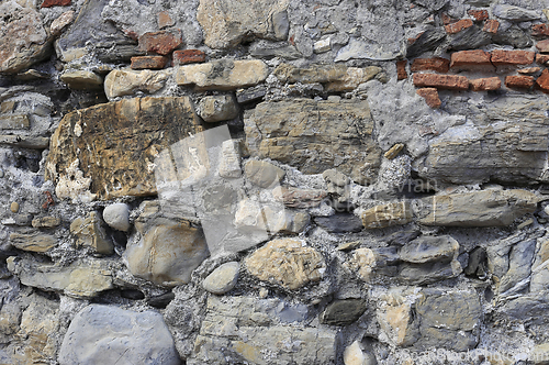 Image of Very old wall from stones of various shapes and red bricks