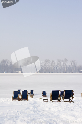 Image of empty deckchairs on a frozen lake