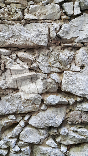 Image of Very old stone wall, close-up architectural texture