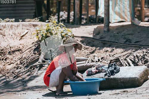 Image of Malagasy woman washes laundry, Madagascar countryside