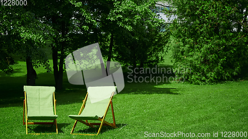 Image of Two resting chairs in the city park