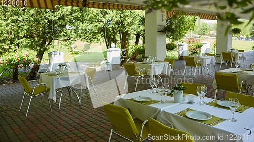 Image of terrace summer cafe with tables and chairs for people, an empty institution for recreation, nobody