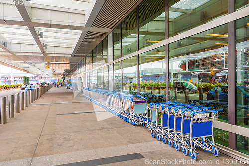 Image of luggage carts by airport entrance