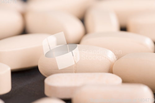 Image of convex light-colored pills