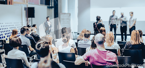 Image of Business speaker giving a talk at business conference event.