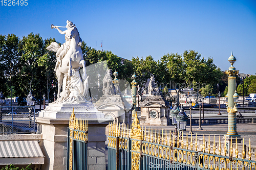 Image of Marble statue and the Tuileries Garden entrance gate, Paris