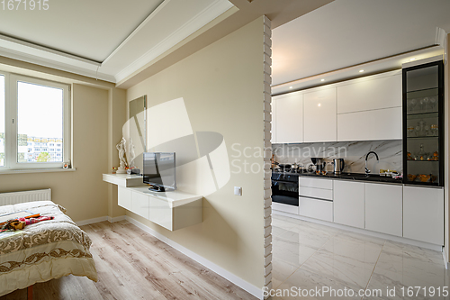 Image of Modern studio apartment with white kitchen in classic style