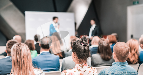 Image of Pitch presentation and project discussion at business convention or team meeting. Audience at the conference hall. Business and entrepreneurship symposium.