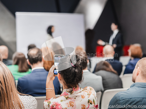 Image of Pitch presentation and project discussion at business convention or team meeting. Audience at the conference hall. Business and entrepreneurship symposium.