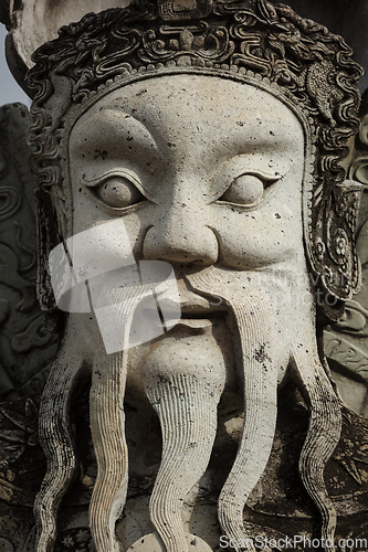 Image of Wat Pho stone guardian face close up, Thailand