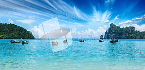 Image of Long tail boat on beach on sunset