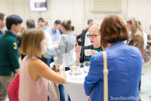 Image of People interacting during coffee break at medical or scientific conference.