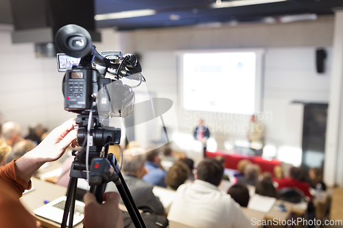 Image of Television broadcasted press conference.