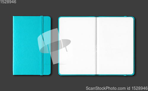 Image of Aqua blue closed and open notebooks isolated on black